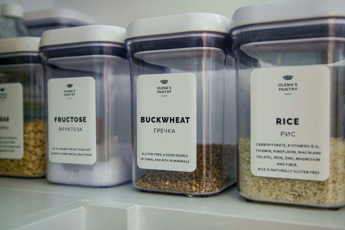 Compact organized kitchen with wooden shelves, storage containers, and tidy counters