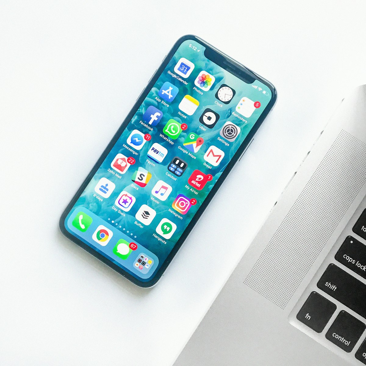 Modern smartphone lying on a clean wooden desk with thoughtful interface layout